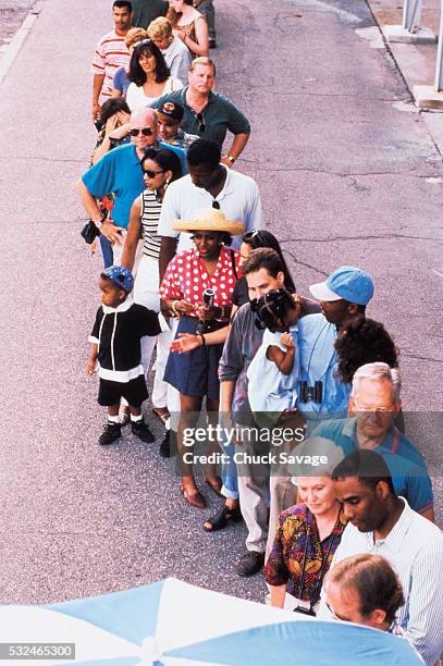 people standing in line at a stadium - waiting in line stock-fotos und bilder