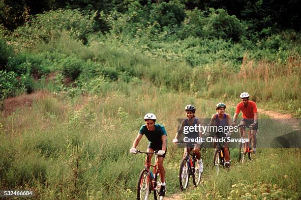 couples mountain biking - white spandex shorts stockfoto's en -beelden