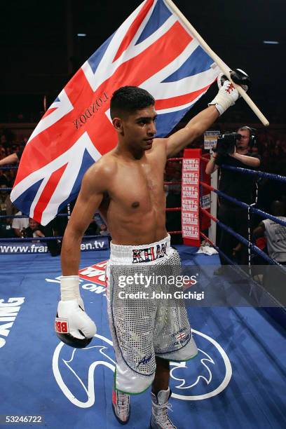 Amir Khan celebrates after stopping David Bailey in the first round during his professional debut in a lightweight fight at the Bolton Arena on July...