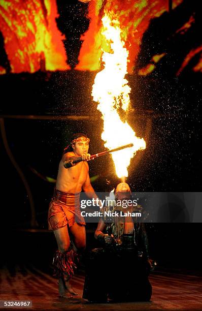 Cirque du Soleil performer Karl Sanft lights his props during the opening ceremony for the XI FINA World Championships on July 16, 2005 at the Parc...