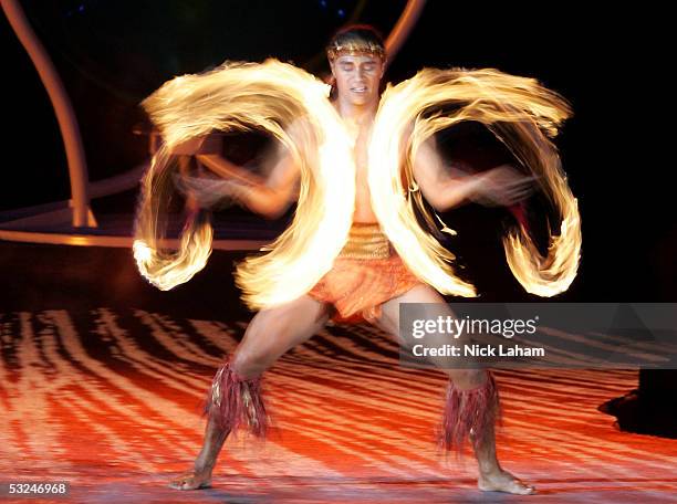 Cirque du Soleil performer Karl Sanft twirls fire during the opening ceremony for the XI FINA World Championships on July 16, 2005 at the Parc...