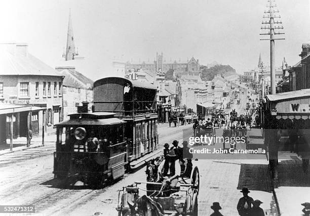 Steam tram and horse drawn wagons on George Street west with Sydney University at the top of the hill in 1880, Sydney, Australia.