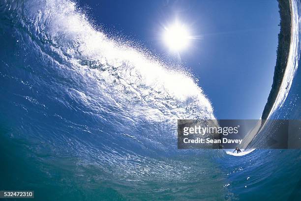 surfing a tubular wave - north pacific stock pictures, royalty-free photos & images