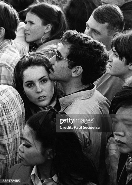 View of a couple standing together amid a large crowd during the Human Be-In held at Golden Gate Park, San Francisco, California, January 14, 1967.