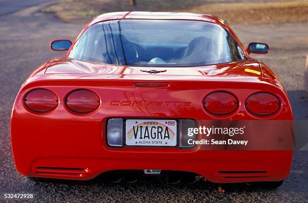 "viagra" vanity plate on red corvette - chevrolet corvette stock pictures, royalty-free photos & images