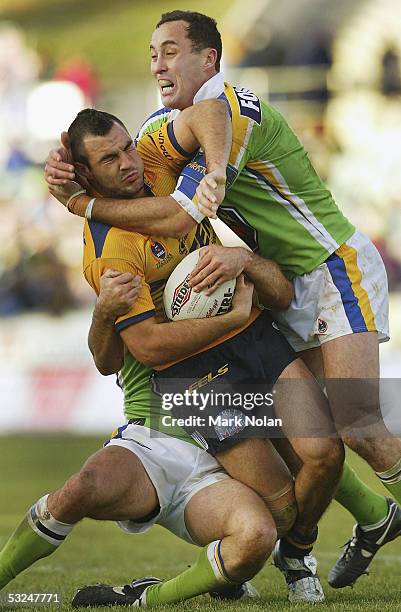 Wade McKinnon of the Eels is tackled by Adam Mogg of the Raiders during the round 19 NRL match between the Canberra Raiders and the Parramatta Eels...