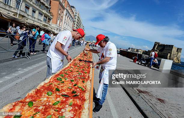Neapolitan pizza makers attempt to make the longest pizza to break a Guinness World Record along the seafront of Naples, on May 18, 2016. For the...