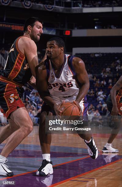 Alton Ford of the Phoenix Suns moves to take a shot against Predrag Dronjak of the Seattle SuperSonics during the pre-season game at the America West...