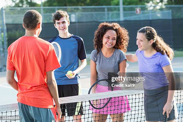 Young girl with disability playing tennis with 3 friends