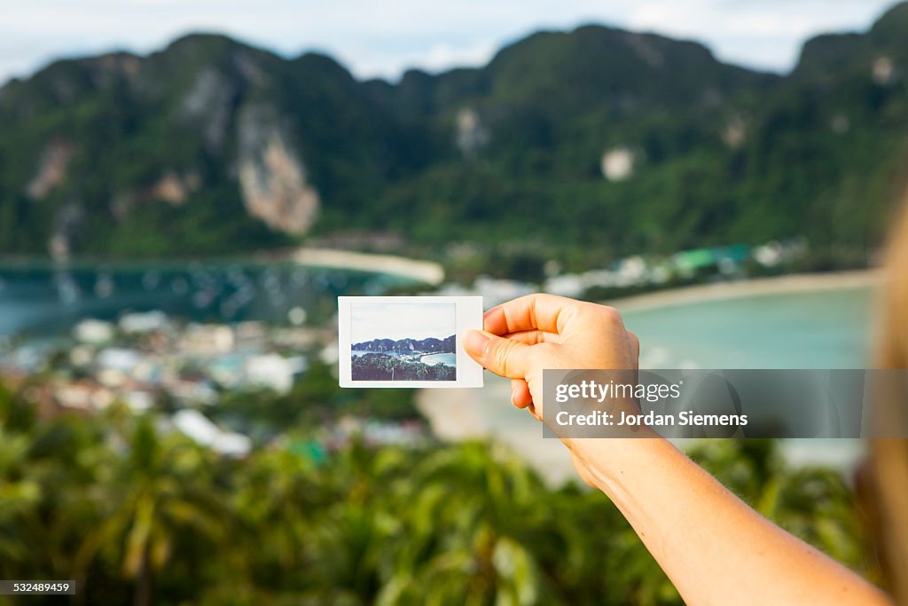 Hand holding polaroid picture.