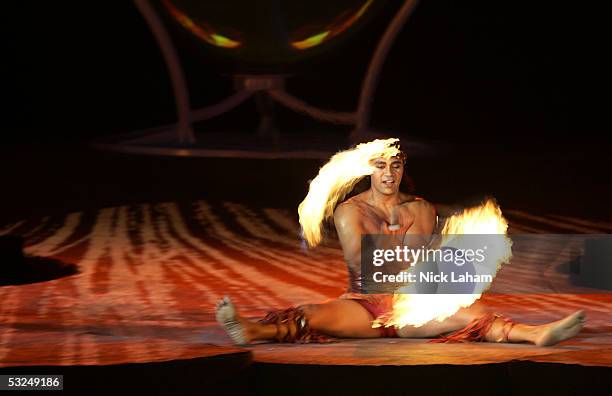Cirque du Soleil performer Karl Sanft twirls fire during the opening ceremony for the XI FINA World Championships on July 16, 2005 at the Parc...
