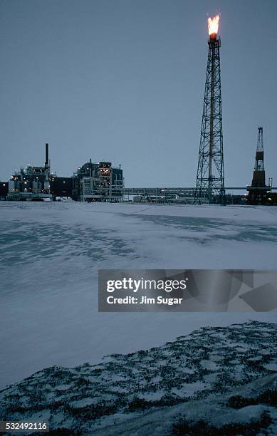 burning gas in an oilfield - north slope alaska stock-fotos und bilder