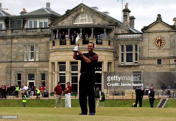 Tiger Woods of the USA holds the Claret Jug aloft in front of the R&A Clubhouse after securing a five shot victory at the 134th Open Championship at...