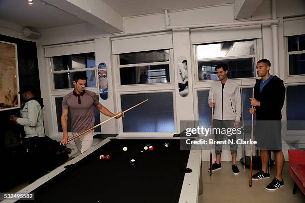 Models are seen playing pool prior to participating in a fashion show at the launch of Michael Strahan's new MSX clothing line for JC Penney on May...