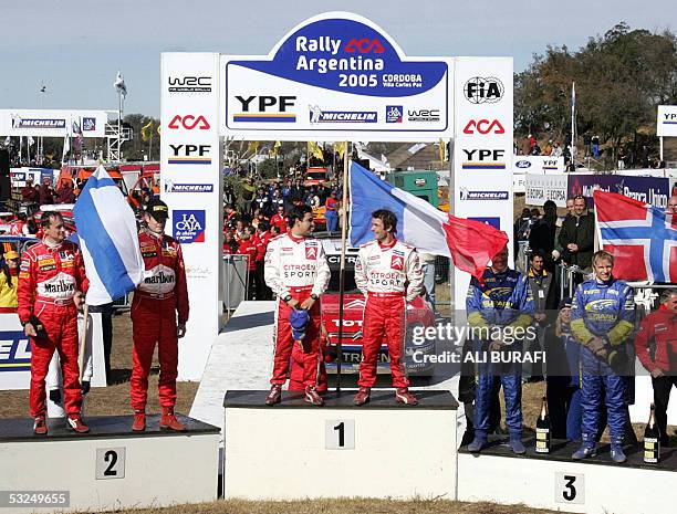 Winners of the 25th Rally Argentina 2005 French Sebastien Loeb and Daniel Elena of Citroen Xsara listen to their national anthem during the podium...