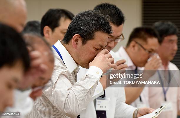 Experts taste sake, or rice wine, poured from bottles that had the brand names hidden during a sake competition in Tokyo on May 19, 2016. Some 1,500...