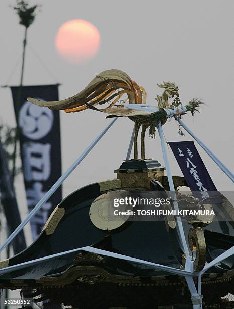 Portable shrine is carried by local residents in the morning sunrise during the annual Hamaori 'going down to the beach', festival in Chigasaki,...