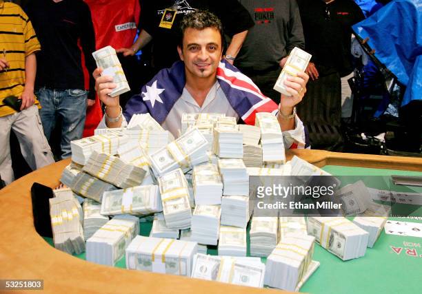 Australian Joseph Hachem poses with some of the $7.5 million he won on the final day of competition at the World Series of Poker no-limit Texas Hold...