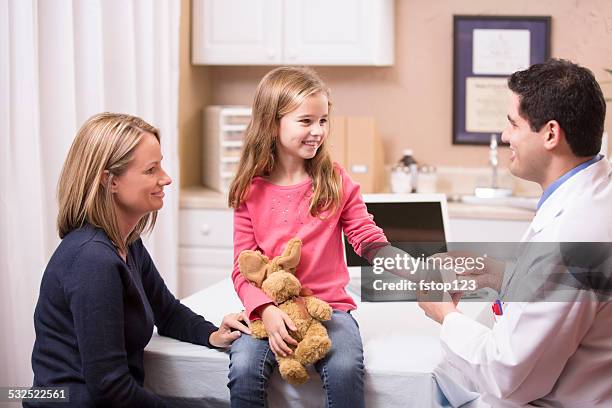 cute little girl patient with pediatrician doctor, mother. latin descent. - wrapping arm stock pictures, royalty-free photos & images