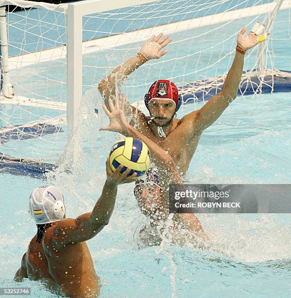 Italy's goalkeeper Fabio Violetti goes up to block as Spain's Gabriel Hernandez prepares to fire the ball on goal during their preliminary Men's...