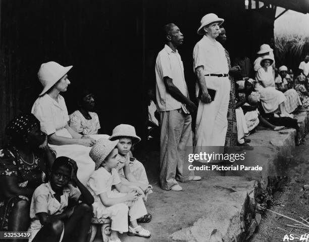 Alsatian-born German theologian, physician, and medical missionary Albert Schweitzer conducts a Sunday worship service with two interpreters at the...