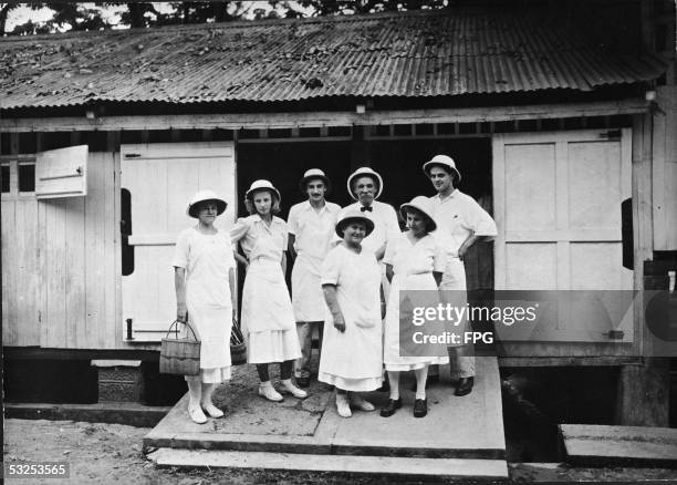 Alsatian-born German theologian, physician, and medical missionary Albert Schweitzer poses with his staff at the hospital he founded at Lambarene,...