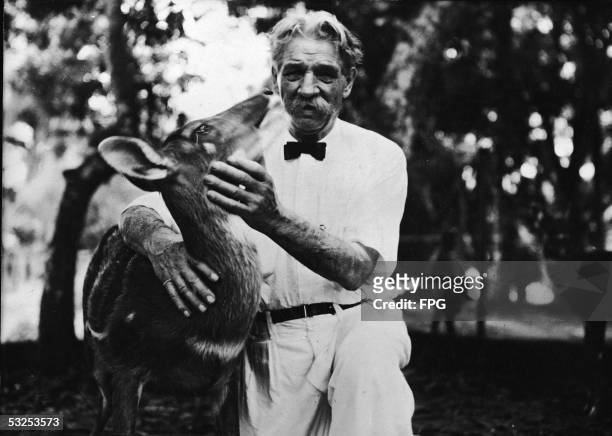 Alsatian-born German theologian, physician, and medical missionary Albert Schweitzer pets an antelope on the grounds of the hospital he founded at...