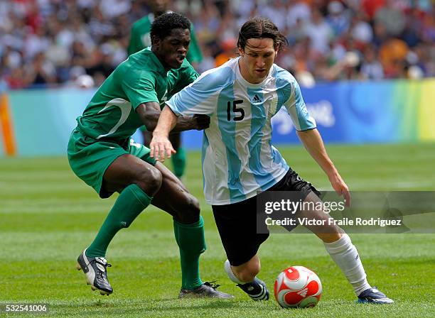 August 2008, Beijing, China --- Lionel Messi of Argentina and Dele Adeleye of Nigeria fight for the ball during the men's soccer final at the...