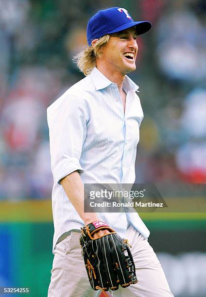 Actor Owen Wilson reacts after throwing out the ceremonial first pitch before a game against the New York Yankees and the Texas Rangers on July 18,...