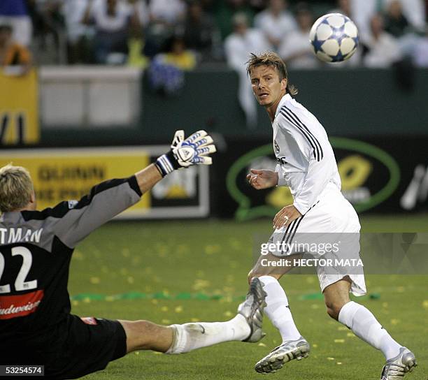 Real Madrid's midfielder David Beckham shoots the ball over Los Angeles Galaxy's goalkeeper Kevin Hartman during the first half of their friendly...