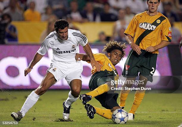 Luis Filipe Figo of the Real Madrid and Guillermo Pando Ramirez of the Los Angeles Galaxy clash during the game at the Home Depot Center on July 18,...