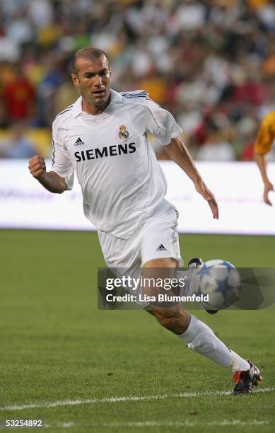 Zinedine Zidane of Real Madrid dribbles against the defense of the Los Angeles Galaxy during the game at the Home Depot Center on July 18, 2005 in...