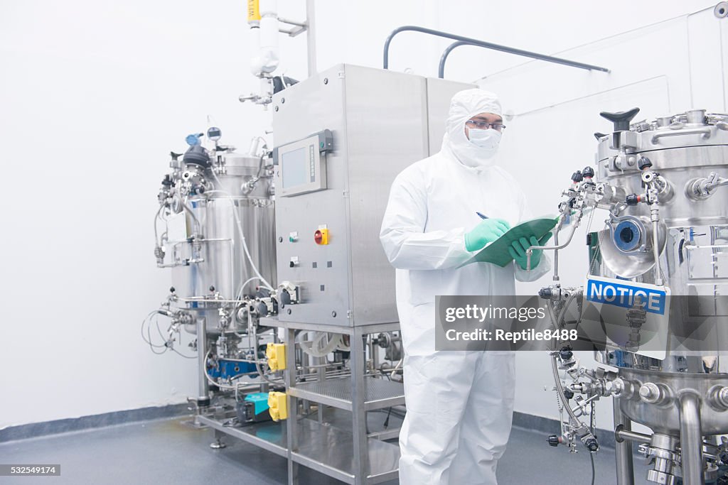 Scientist with bioreactor