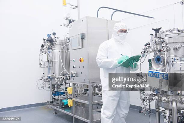 scientist with bioreactor - cleanroom stock pictures, royalty-free photos & images