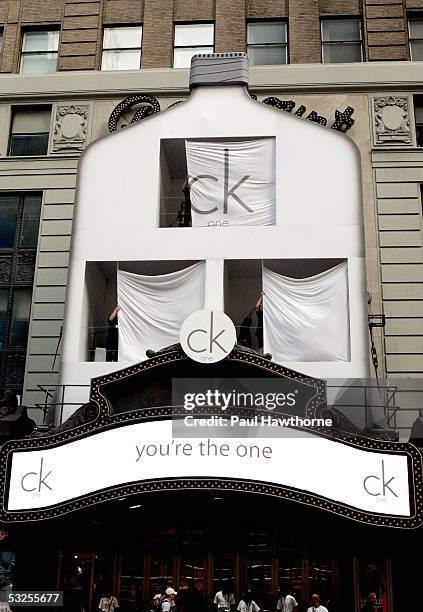 The CK One bottle billboard is unveiled to reveal CK One models living in the advertisement overlooking the streets of Times Square July 19, 2005 in...