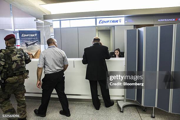 Soldier passes the EgyptAir Airlines ticket office at Charles de Gaulle airport, operated by Aeroports de Paris, in Roissy, France, on Thursday, May...