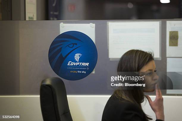 An employee sits at EgyptAir Airlines ticket office at Charles de Gaulle airport, operated by Aeroports de Paris, in Roissy, France, on Thursday, May...