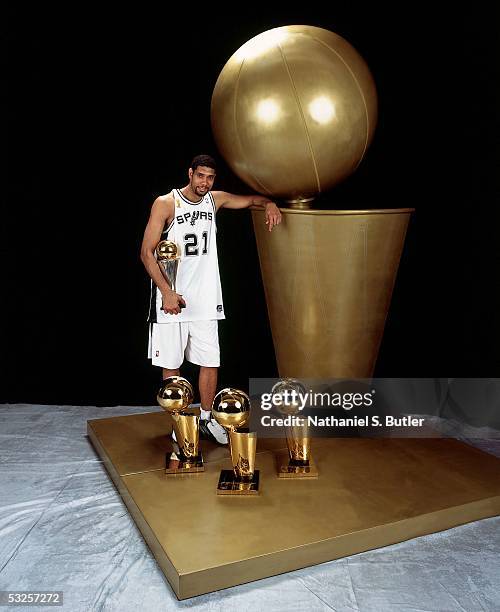 Tim Duncan of the San Antonio Spurs poses with his championship trophies after winning Game Seven of the 2005 NBA Finals June 23, 2005 at the SBC...