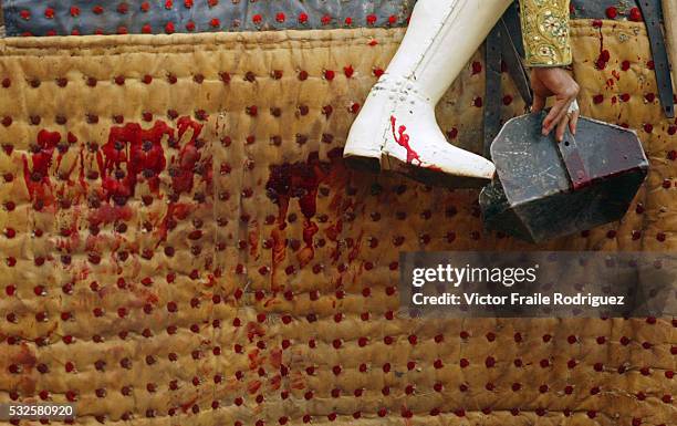 Spanish picador adjusts his stirrup after driving his wounding remark into a bull during the "Santiago" bullfighting fair in the northern Spanish...