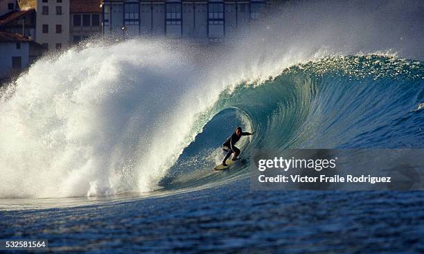 Spanish surfer Iker Acero rides a big wave in Mundaka, one of Europe's most famous beach break waves. Photo by Victor Fraile --- Image by © Victor...