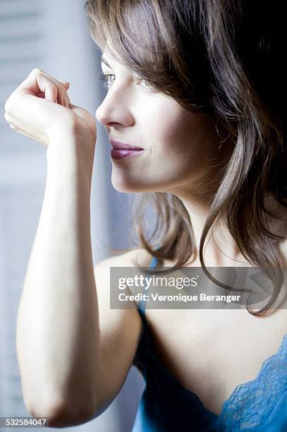 woman smelling perfume on her wrist. - wrist stock pictures, royalty-free photos & images