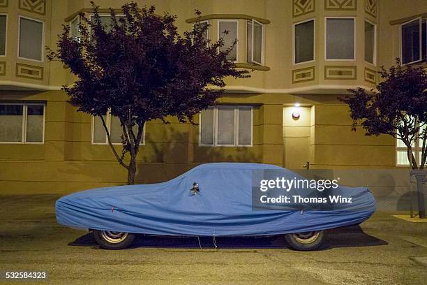 covered car at night - covered car street stock pictures, royalty-free photos & images