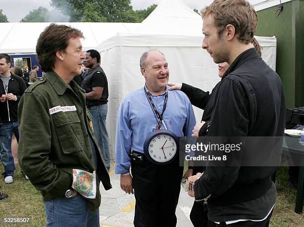 Musicians Sir Paul McCartney and Coldplay's Chris Martin and original Live Aid promoter Harvey Goldsmith are seen backstage at "Live 8 London" in...