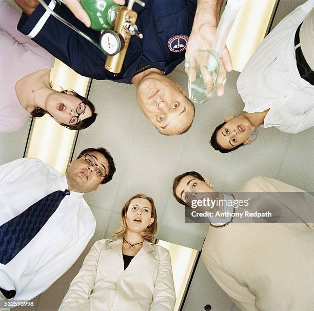 people huddled over person who fainted - fainting fotografías e imágenes de stock