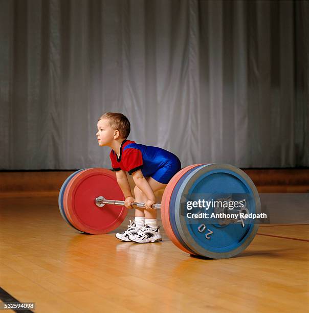 boy preparing to lift barbell and weights - young kid and barbell stock-fotos und bilder