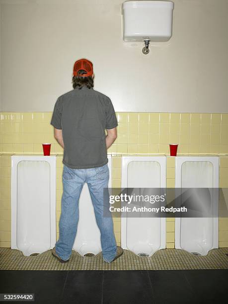 young man taking a pee - urinating stock-fotos und bilder