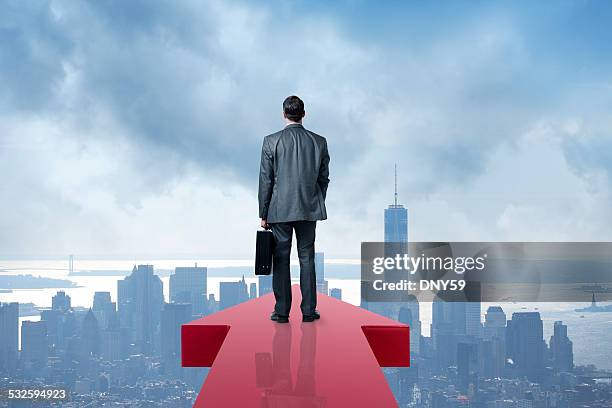 businessman holding briefcase at the end of an arrow - leading edge stock pictures, royalty-free photos & images