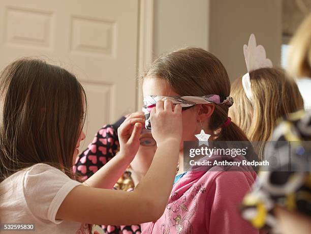 girl having blindfold tied - 目隠し ストックフォトと画像