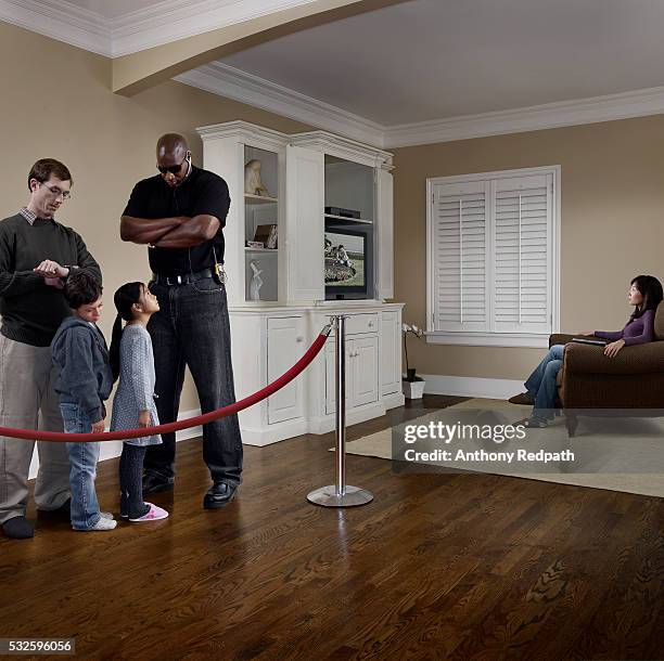 a family waits in line to watch television in their living room - vintage funny black and white stock-fotos und bilder