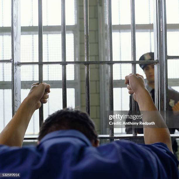 prisoner holding cell bars - prison uniform stock pictures, royalty-free photos & images